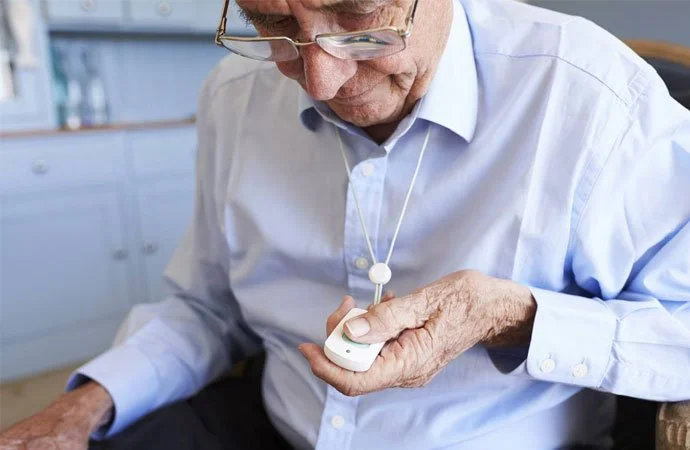 Medical alert button worn on the wrist
